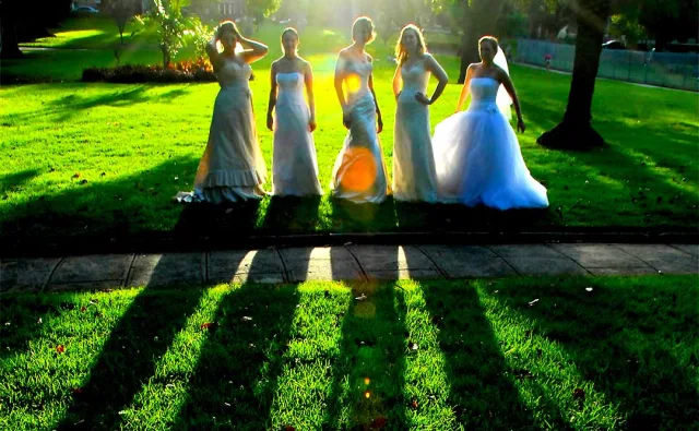 Group of friends wearing wedding dresses during a BBFFF reunion dinner in Sydney.